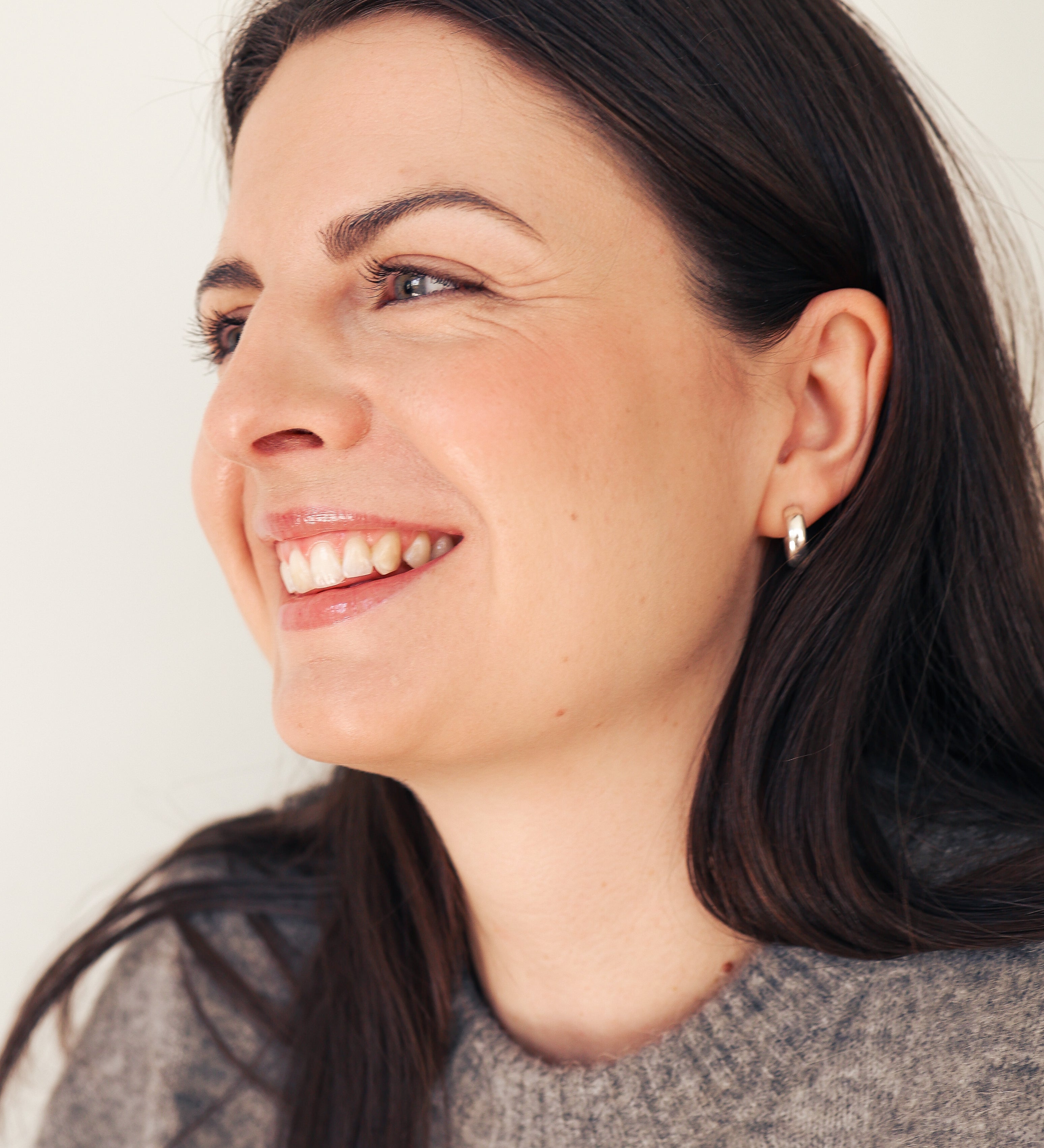 Young woman with beautiful smile looking to the side 