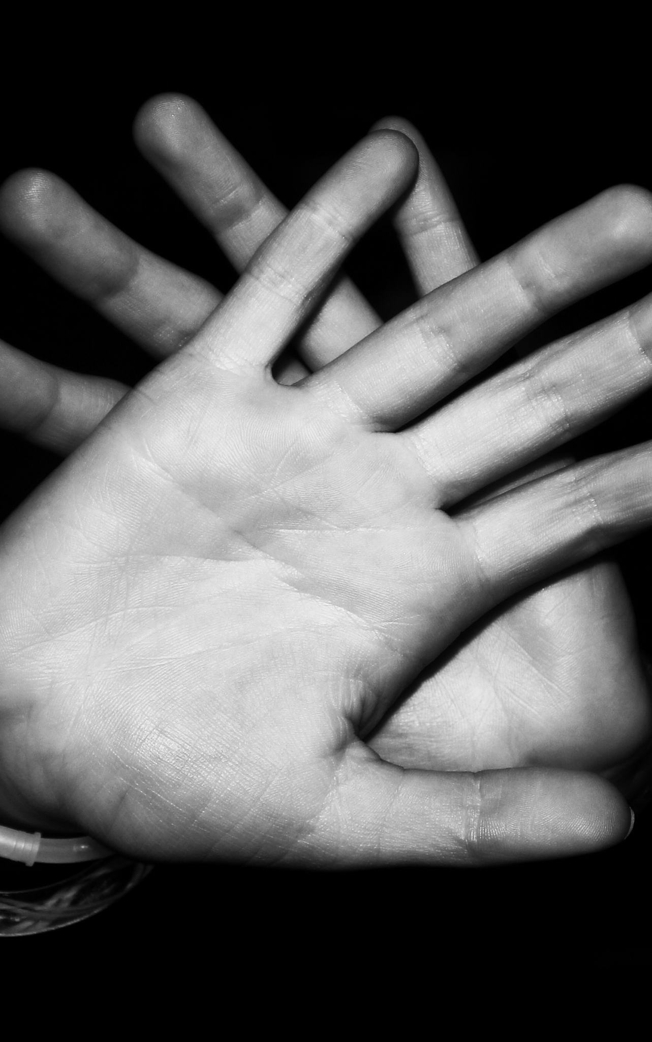 Two palms crossing over each other in BW image