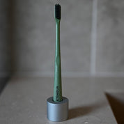 Etinour Essential Toothbrush in minimal Scandinavian bathroom with taupe stone